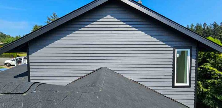 House exterior wall painted gray to complement the asphalt roof shingle