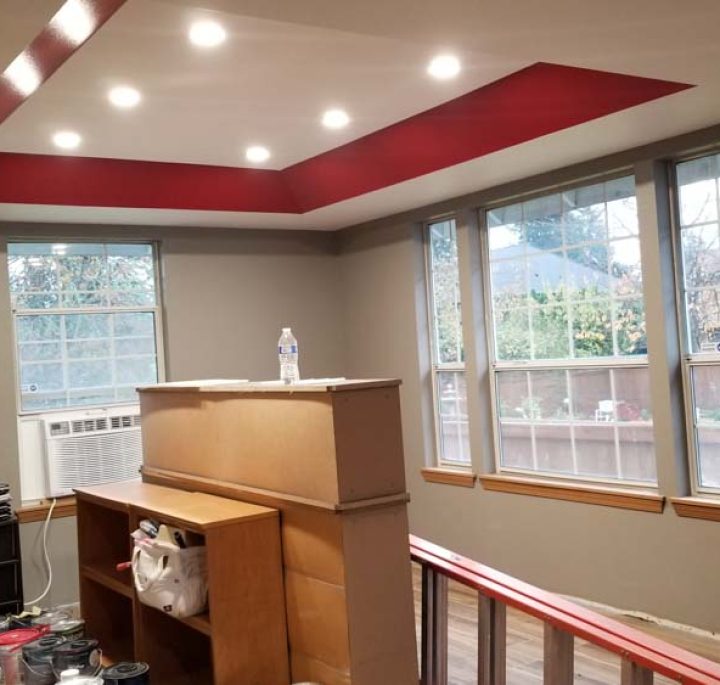An interior paint project: gypsum ceiling design with frame and edges painted red while taupe on the walls and off- white on the ceiling